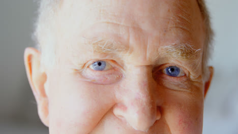 close-up of caucasian senior man looking at camera in a comfortable home 4k