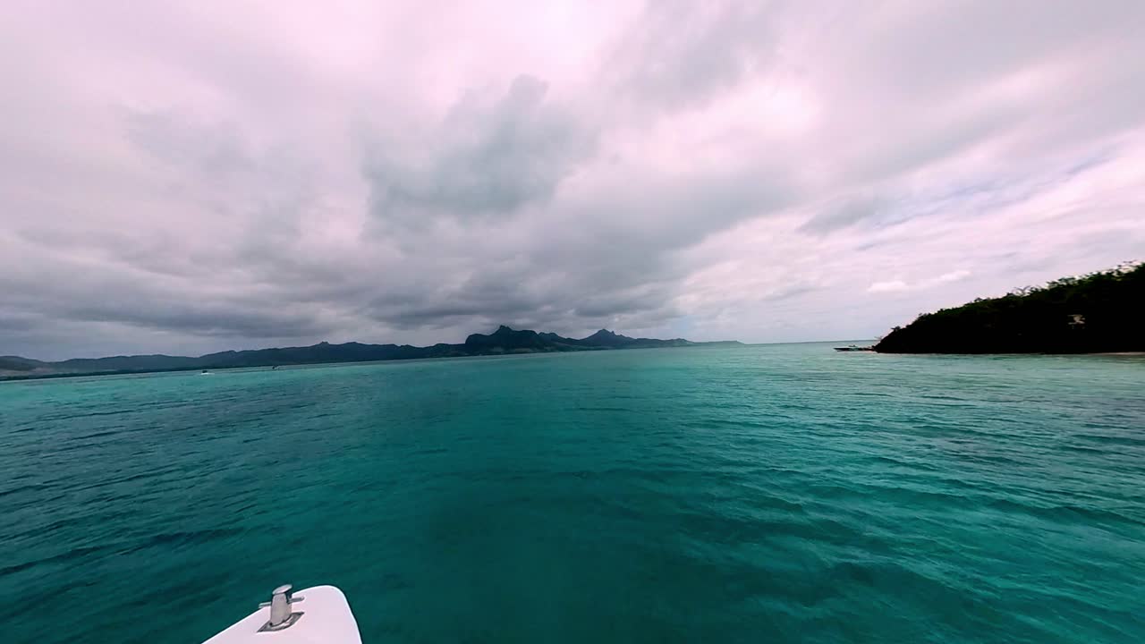 Relaxing boat tour through the clear turquoise waters of Mauritius, showcasing beautiful seascapes and tropical scenery.
