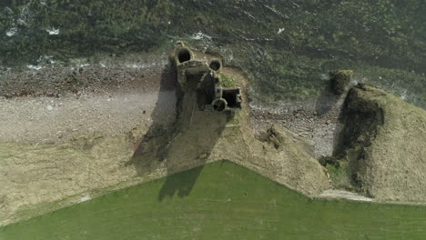 aerial shot looking directly down onto keiss castle on a sunny day, caithness, scotland