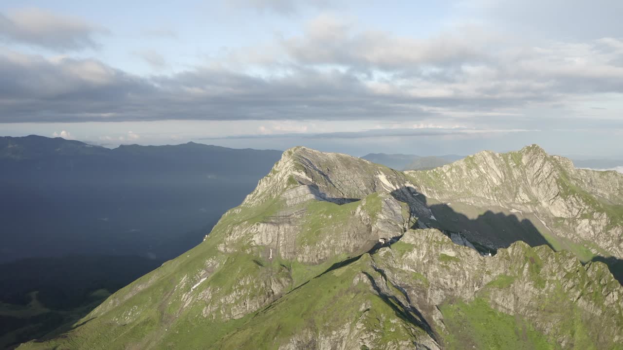 Approach to natural mountain peak cliff terrain at sun light