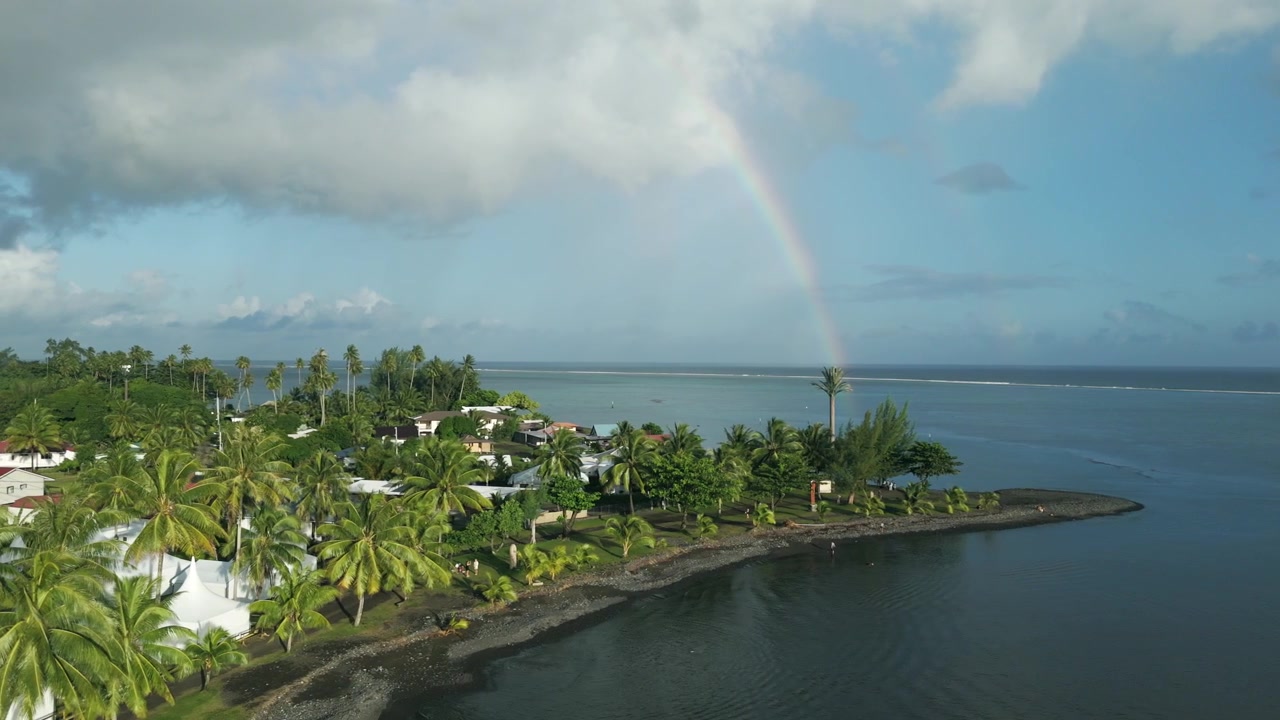 Coconut Trees And Coastline Of Teahupoʻo Village With Rainbow In Tahiti, French Polynesia, France. - aerial shot