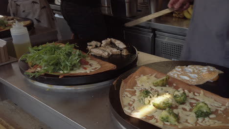 savoury crepes being cooked on an open-air hotplate at a market stall in york, uk