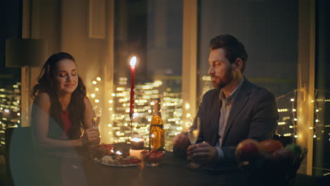 romantic spouses flirting night at candles room closeup. pair drinking wine