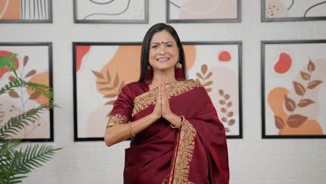 indian woman greeting namaste to the camera