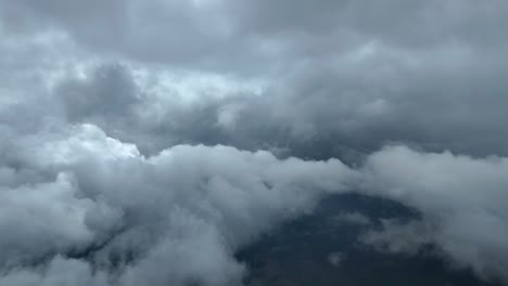 an immersive pilot’s view flying through stormy clouds through the pillot’s eyes from a jet cockpit.