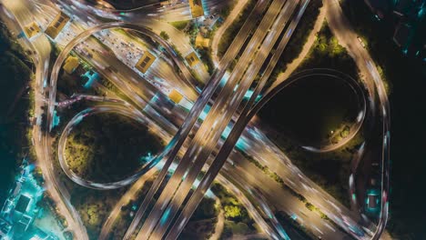 time-lapse or hyper-lapse aerial view highway road roundabout circle or intersection traffic at night for transportation concept.