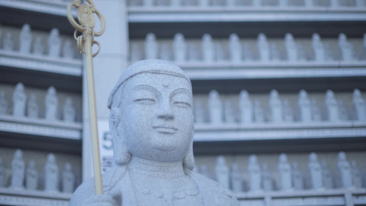 Testa di Buddha scolpita nella pietra al Tempio Bongeunsa a Gangnam, Seoul, Corea del Sud. Scatto ravvicinato dal basso