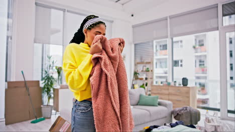 laundry, happy and woman smell clothes with smile