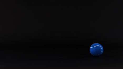 a blue tennis ball moves against a dark background