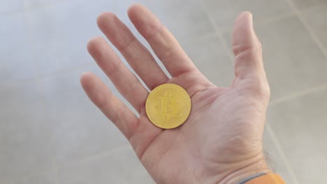 person holding a bitcoin