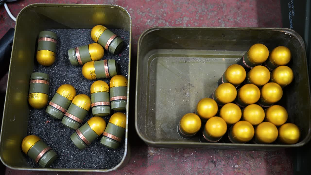 Donetsk region, Ukraine: Grenades get plastic casings at a drone workshop for aerial attachment. Adaptive weapon production redefines modern warfare.