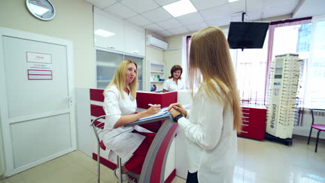 doctor with client at eye hospital. woman at the reception at the eye clinic