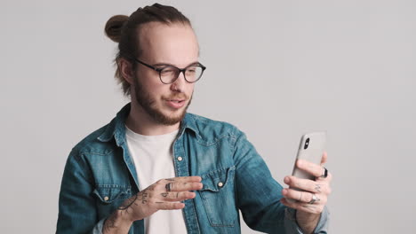 caucasian young man having discussion on a video call.