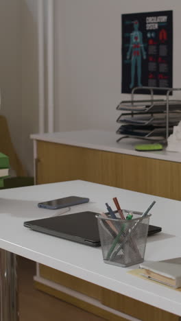 office desk with laptop and stationery