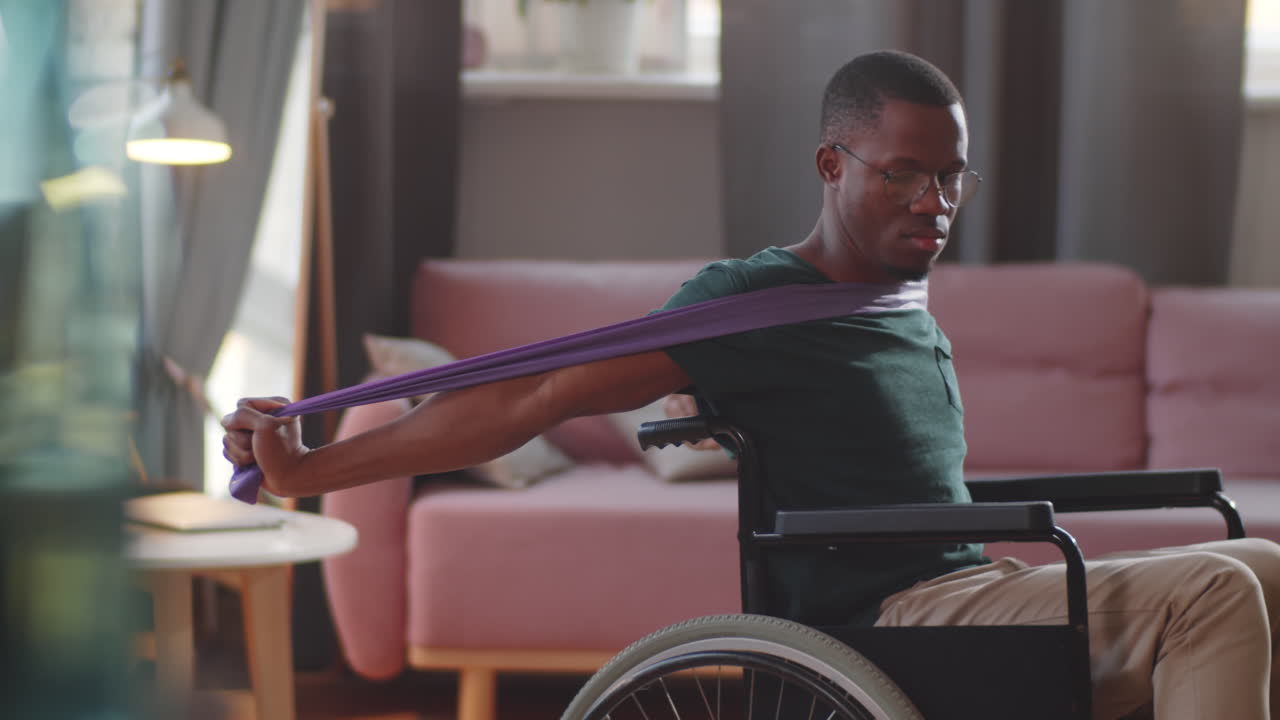 Man in Wheelchair Exercising with Resistance Band