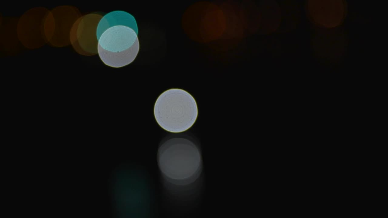 Abstract moving blurry light in the city. Beautiful glittering blurry background at night. From car lights in traffic jam on city street.