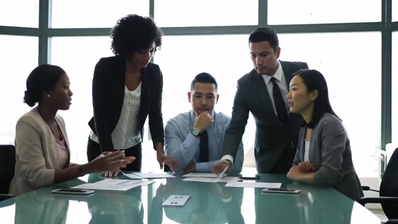 A Collaborative Strategy Session: Diverse Team Engaged in Dynamic Discussion and Decision-Making at a Modern Office Conference Table