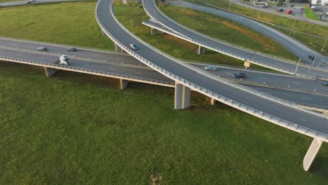 an aerial view: cars and trucks drive over the country bridge with no traffic