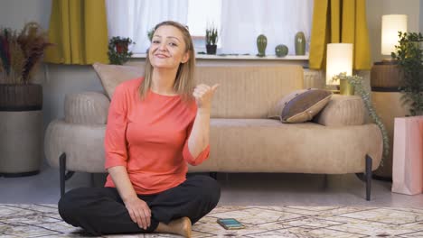 the woman promoting is pointing to the side and laughing.