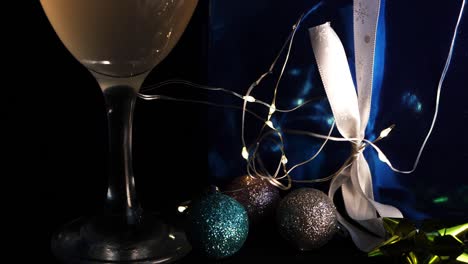 Christmas-decorations-with-drink-and-gift-close-up-panning-shot