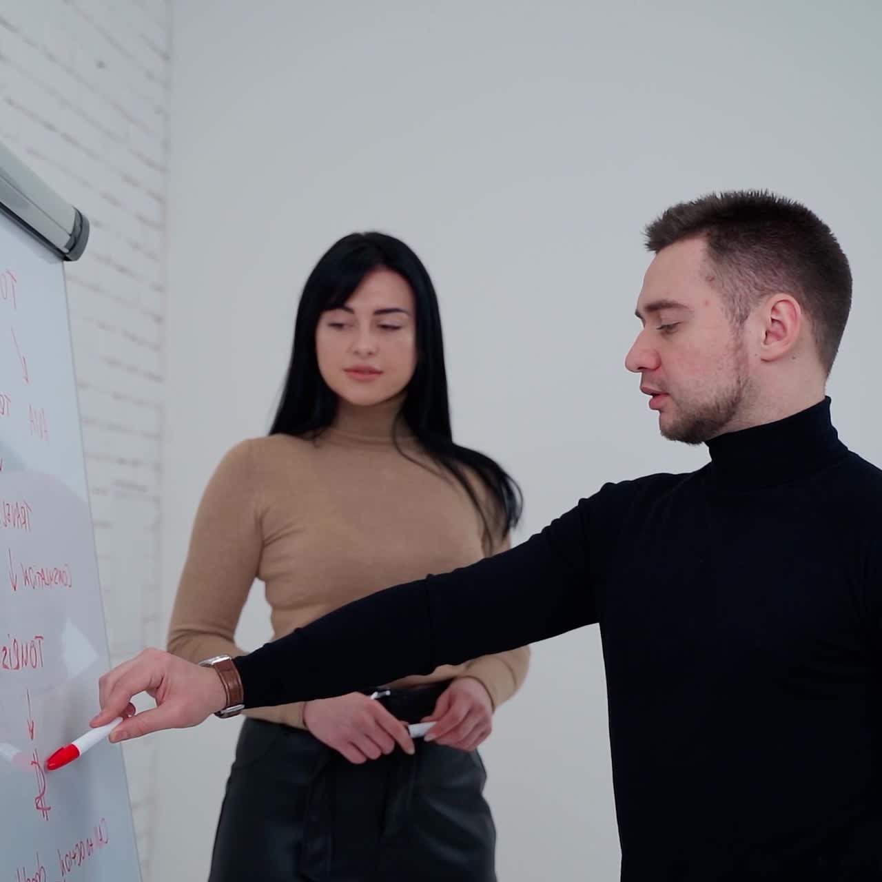 Experienced couple presenting new ideas. Young businessman presenting data idea marketing on a board. Freelance concept. Slow motion.