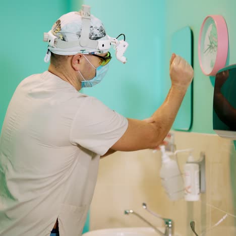doctor washes hands. surgeon disinfects and washing his hands before entering the operating room. surgical hand disinfection. emergency care. surgery detail in hospital.