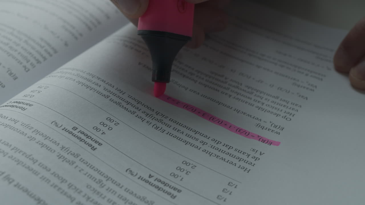 A student highlighting a formula in their book