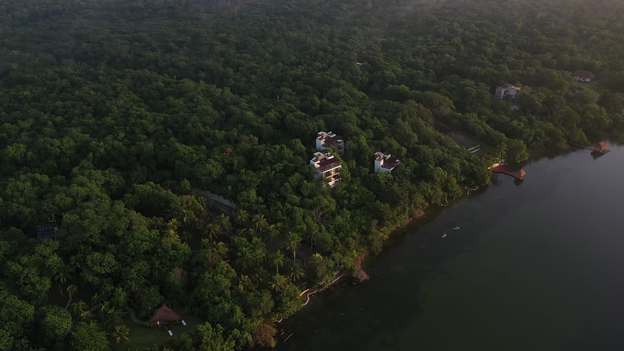 Aerial View, Bacalar Lake Coastline and Villas in Dense Rainforest, Quintana Roo Mexico, Drone Shot
