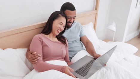 Home-bed,-laptop-and-happy-couple-laughing