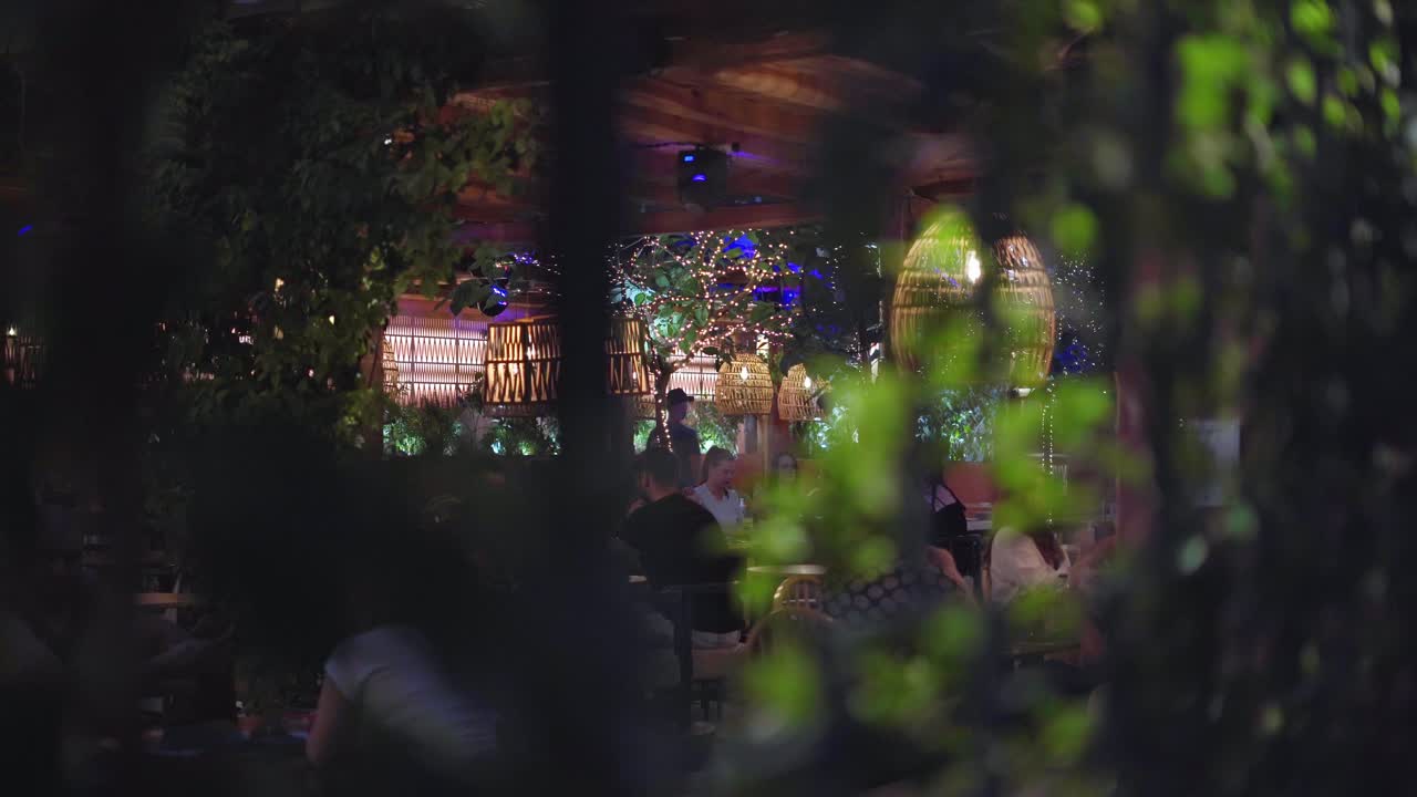 POV of bustling cafe (taverna) scene at night, Mytilene nightlife, Handheld gimbal shot