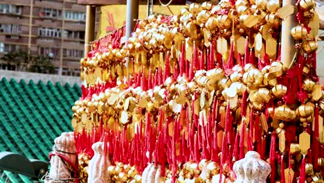 rows of golden bells with red ribbons