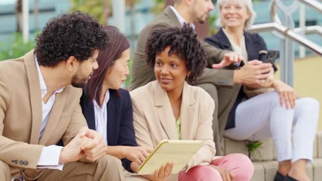 business team meeting outdoors with technology