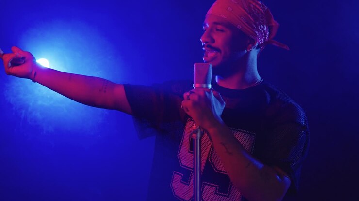 Man singing into a microphone on stage