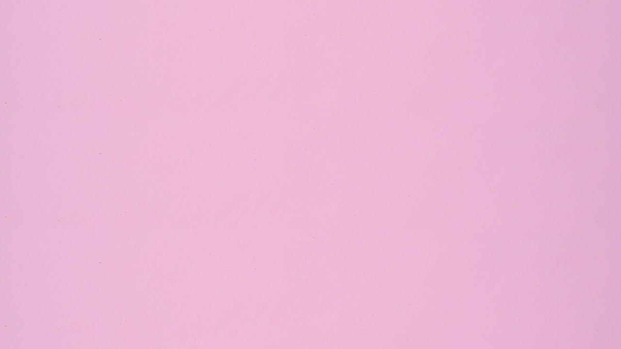 Creative biscuits appear on pastel pink background. Stop motion flat lay. Cookies pattern