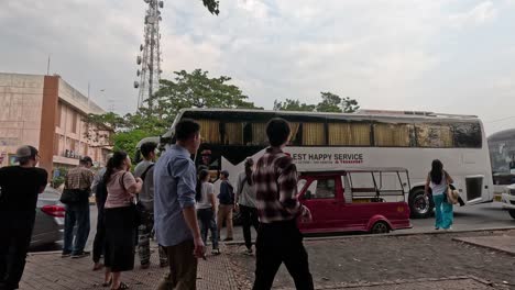 people gathering to board a stationary bus