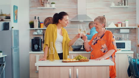 mother and daughter clinking glasses of wine