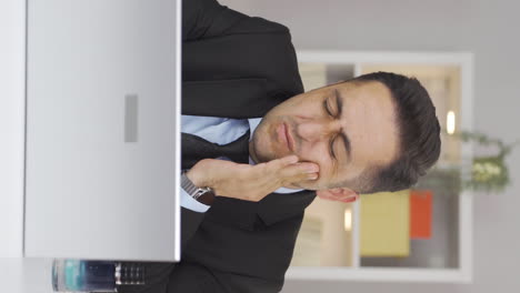 vertical video of home office worker man teeth aches and pains.