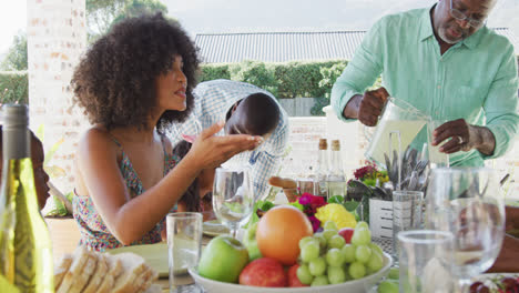 Video-of-african-american-family-spending-time-together-and-having-dinner-outside