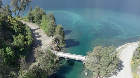 AERIAL---Bridge-over-Correntoso-River,-Neuquen,-Argentina,-forward-lowering