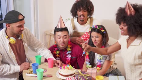 diverse friends celebrate birthday with cake and candles