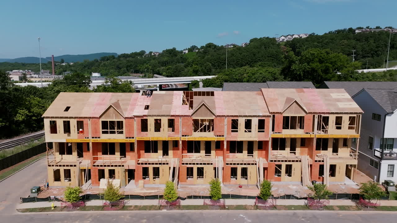 Drone view of new townhomes under construction in Chattanooga, Tennessee, with hills in the background