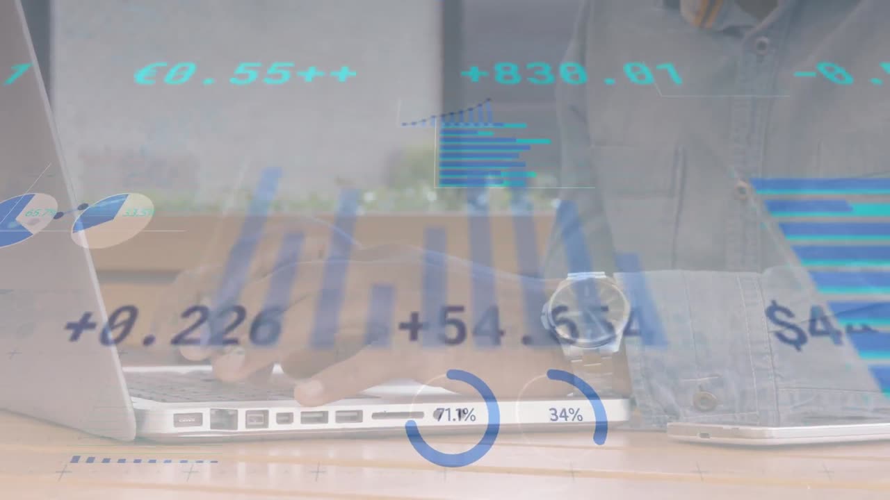 Animation of financial data and graphs moving over hands of biracial man using laptop