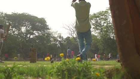 Panning-Shot-of-People-Playing-Cricket