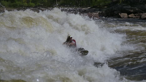 extreme sports white water kayak splashing in the wave