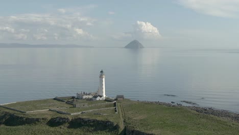 Aerial-view-of-Pladda-Lighthouse-on-the-Isle-of-Arran-on-a-sunny-day,-Scotland