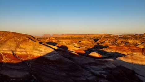 Amazing-Timelapse-as-the-canyon's-shadow-blankets-Bentonite-Hills,-Utah-at-sunset