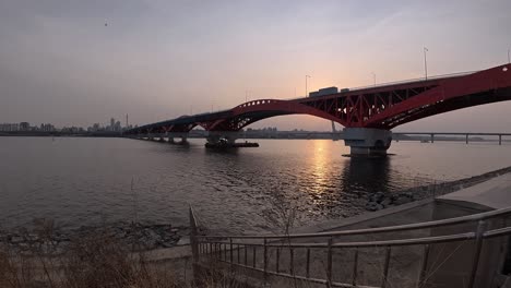 scenic sunset view of seongsan bridge across han river in seoul, south korea, static shot