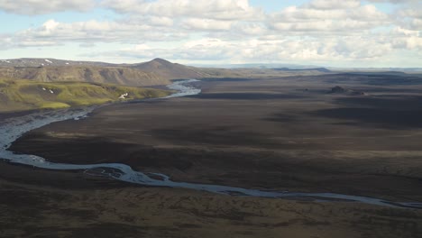 Aerial-panning-shot-of-LAVA-AND-SAND-Desert-Maelifellssandur-in-Iceland-during-cloudy-day,Iceland