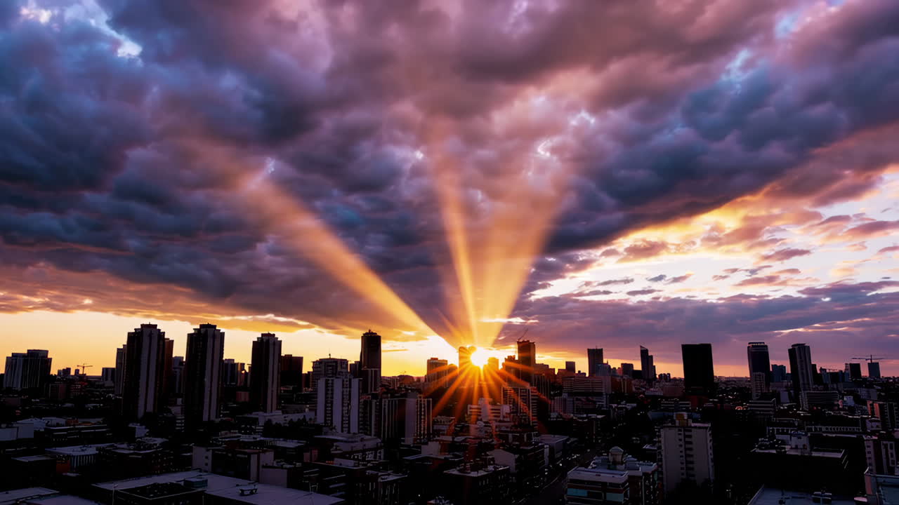 Dramatic Sunbeams Over City Skyline at Sunrise or Sunset