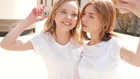 two girls taking a selfie on a rooftop